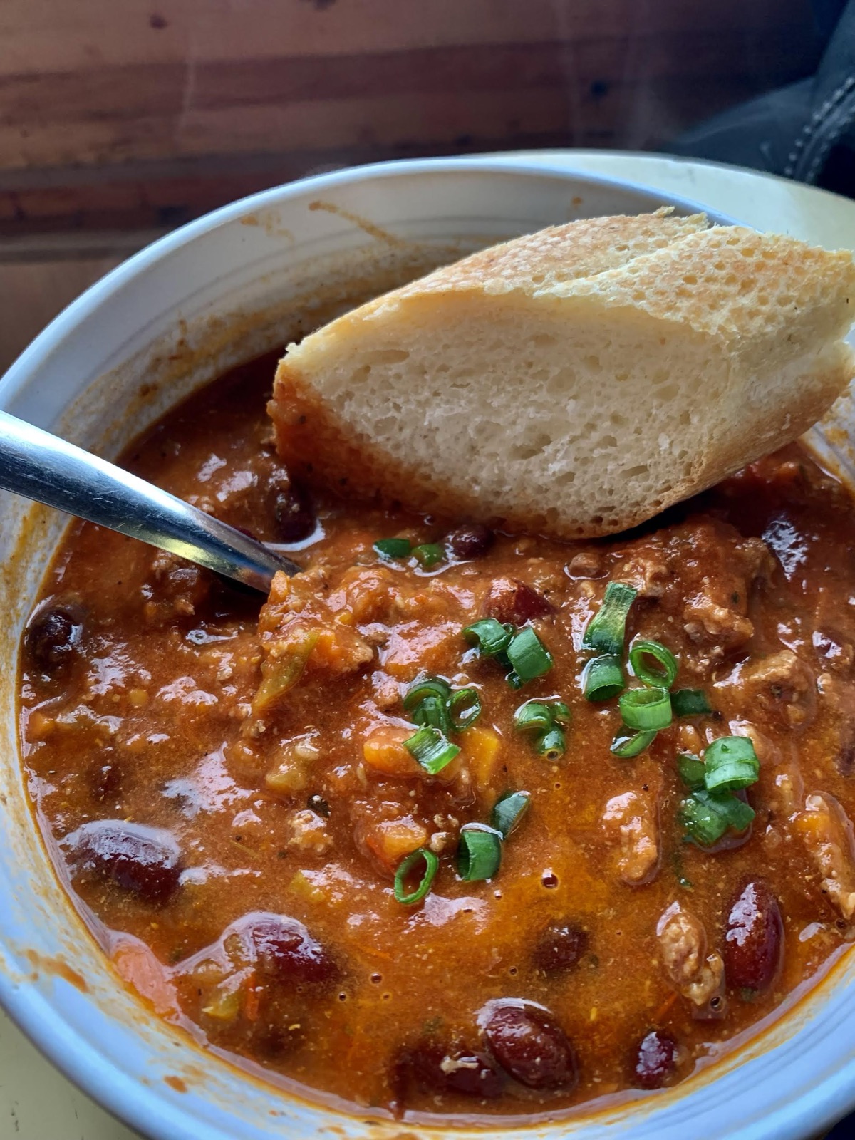 A bowl of chili with fresh bread from the lunch counter