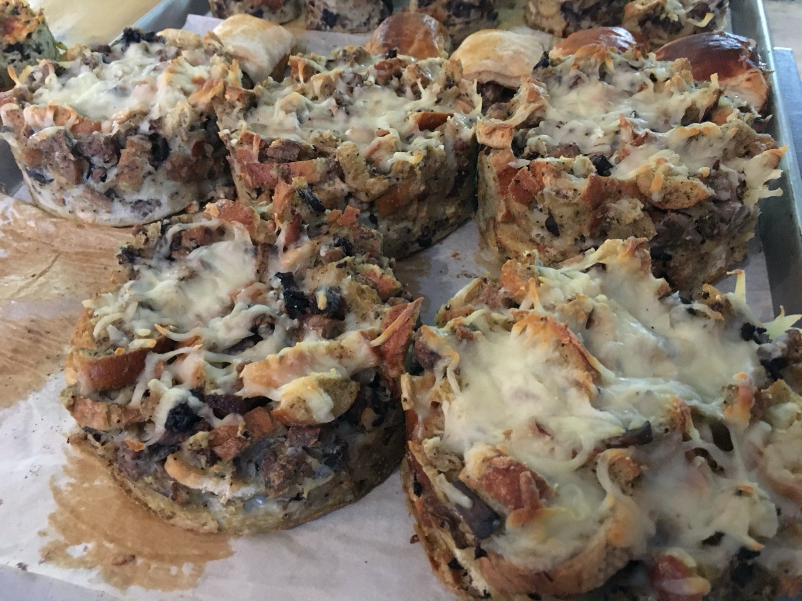 Savoury bakes topped with melted cheese, fresh from the morning oven